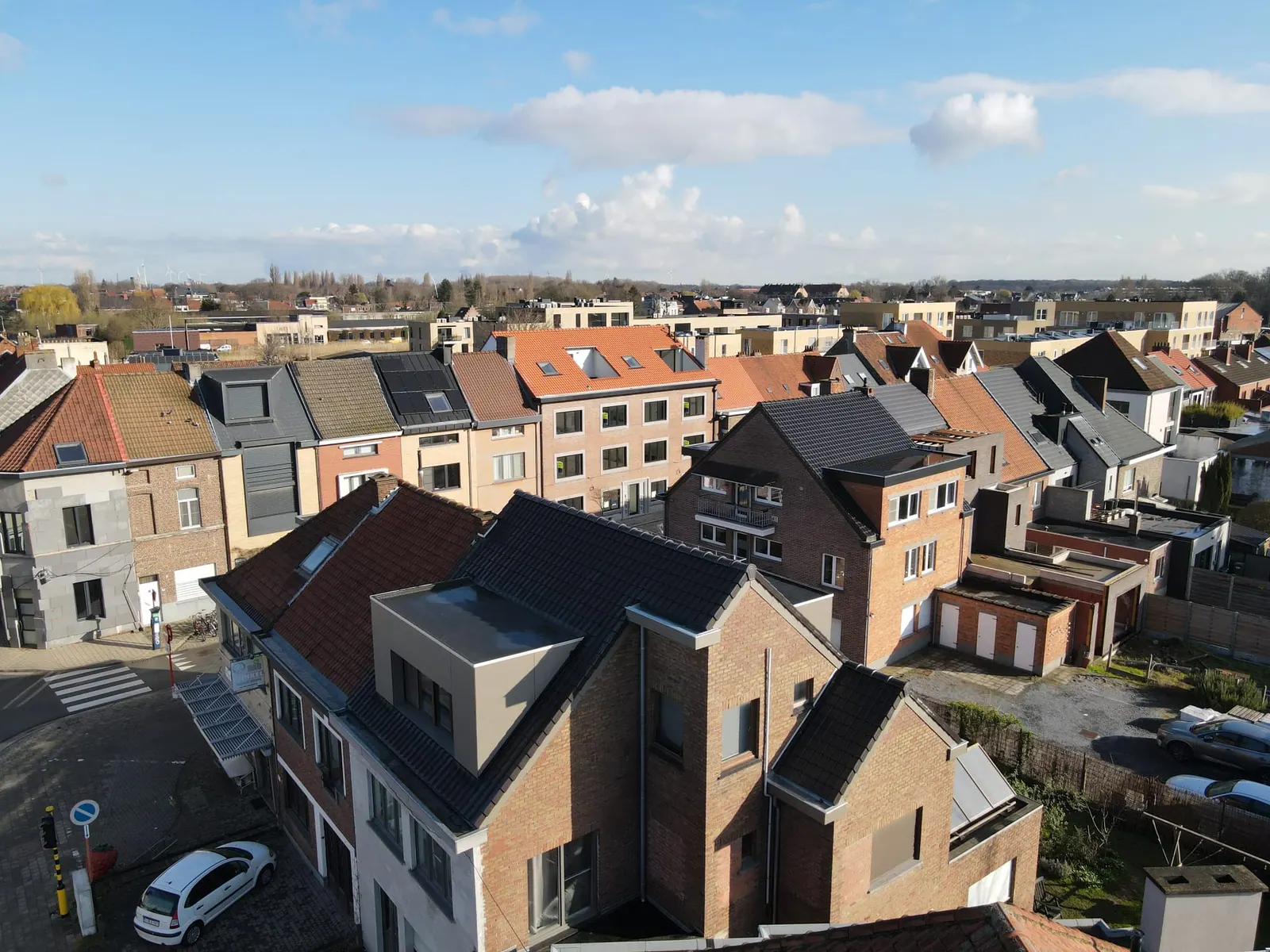 Luchtfoto van een straat met pannendaken en een dakkapel met bekleding